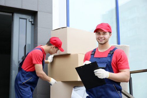 Professional movers handling household items in Highbury