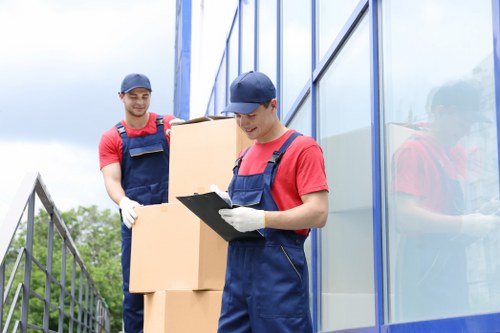 Professional movers handling household items in Old Ford