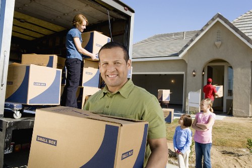 Family unpacking items in their new Holland Park home